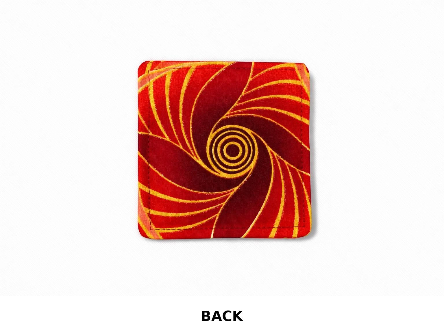 back view of red corner bookmark with maroon, pink, & gold patterns on a light gray background