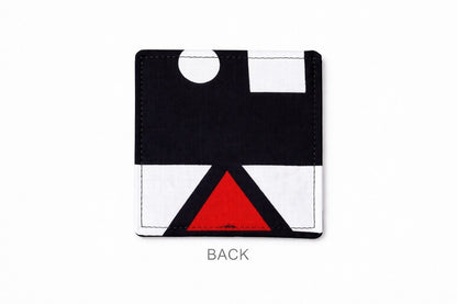 back view of a white corner bookmark with black & red patterns on a light gray background