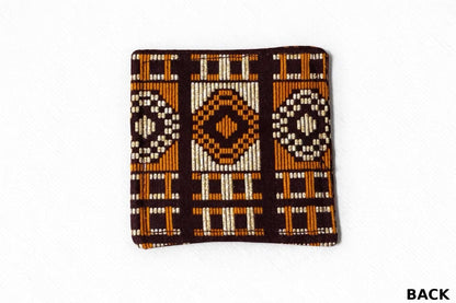 Dark brown, orange, & gold patterned fabric coaster back view