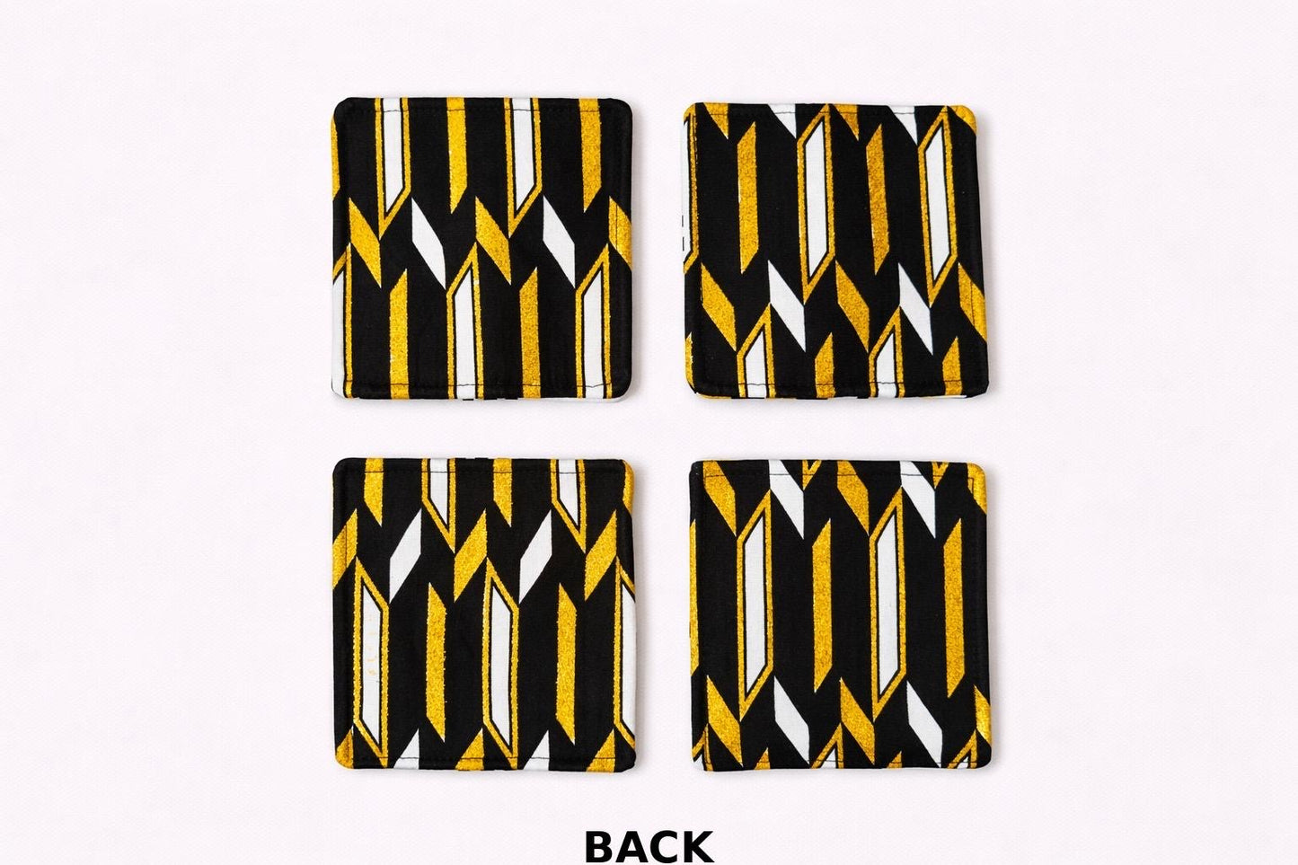 Back view of white, black, & gold patterned fabric coasters 