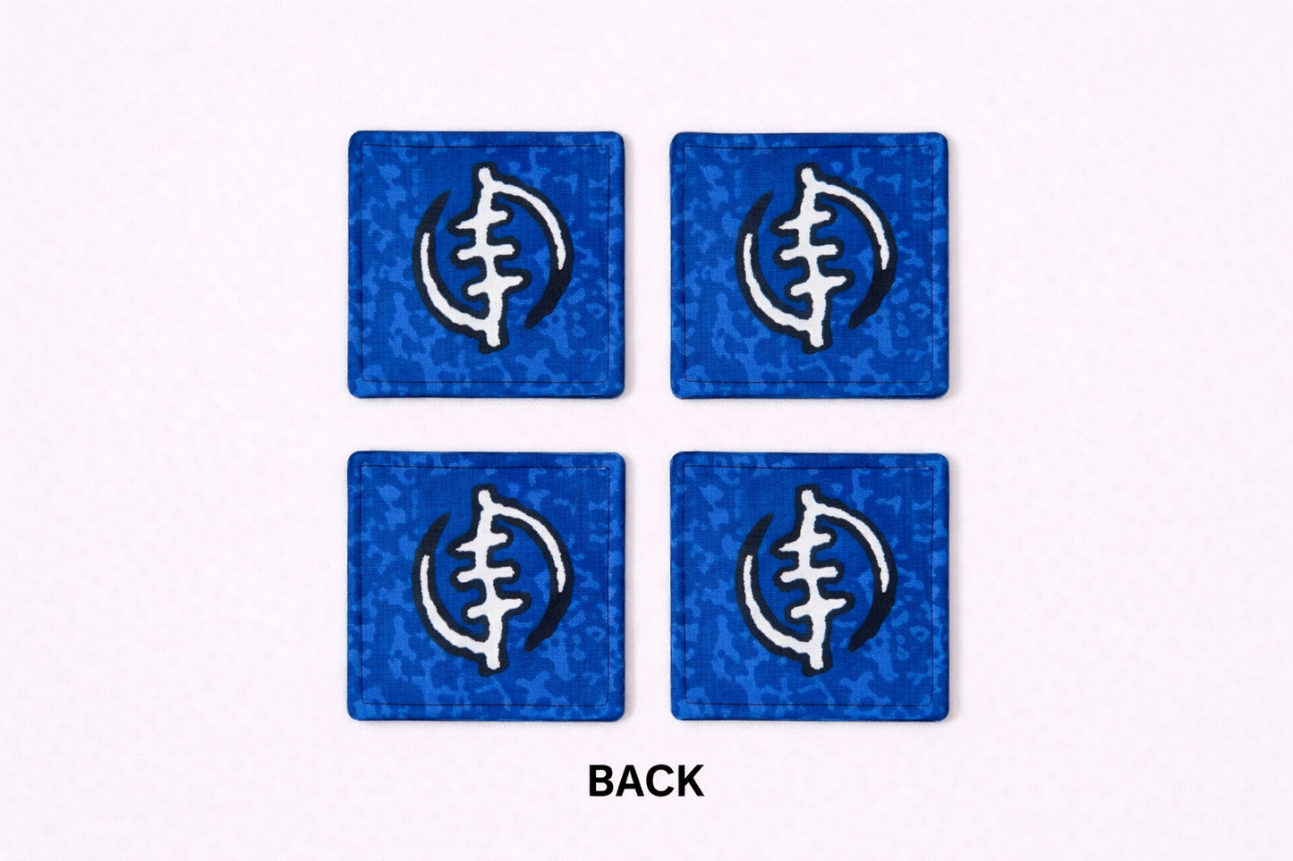 Set of 4 blue, black, & white African fabric coasters on white background