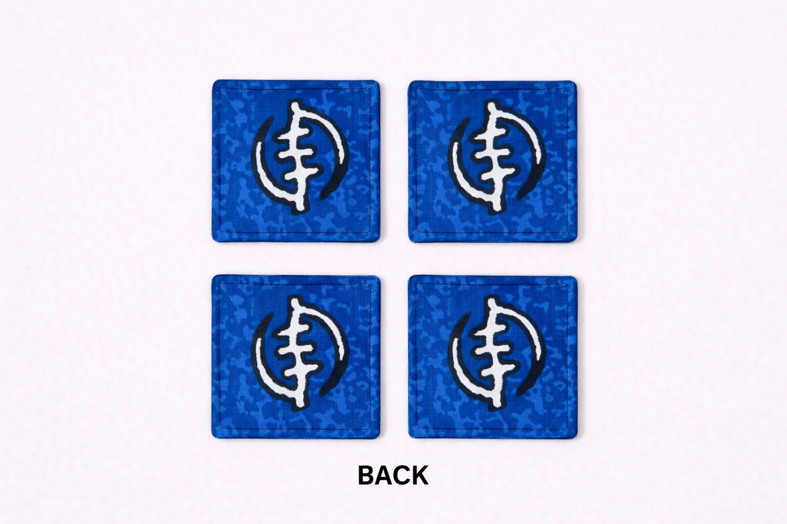 Set of 4 blue, black, & white African fabric coasters on white background