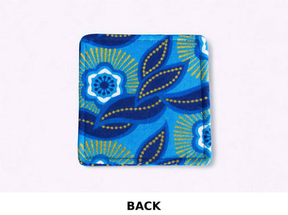 Dark blue, blue, white, & gold African fabric coaster on white background