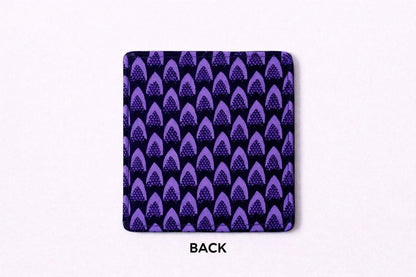 Set of 4 purple and black African fabric coasters on white background