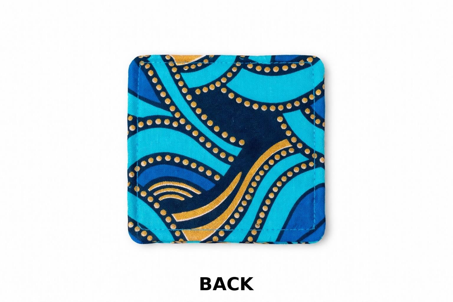 Turquoise, dark blue, & gold African fabric coaster on white background