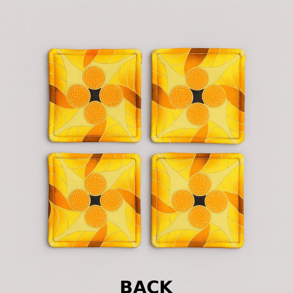 Back view of 4 yellow, brown, orange, & gold African fabric coasters on white background