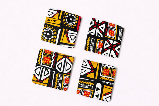 Set of 4 black, white, orange, & red African fabric coasters on white background