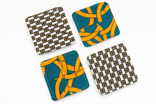 Set of 4 cream, orange, green, & dark blue African fabric coasters on white background