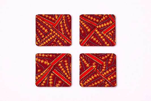 Set of 4 maroon, orange, white & gold African fabric coasters on white background