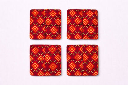 Set of 4 maroon, red, black, & gold African fabric coasters on white background