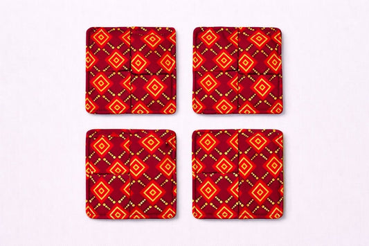 Set of 4 maroon, red, black, & gold African fabric coasters on white background