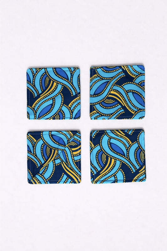 Set of 4 turquoise, dark blue, & gold African fabric coasters on white background