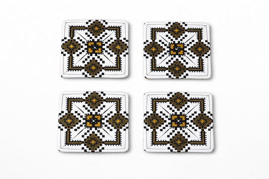 Set of 4 white, black, & gold African fabric coasters on white background