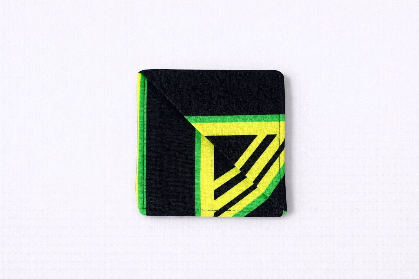 Black, green, white, & yellow corner bookmark on light gray background