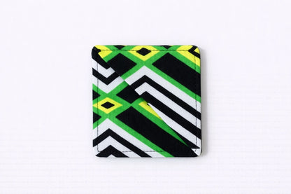 Black, green, yellow, & white corner bookmark on light gray background