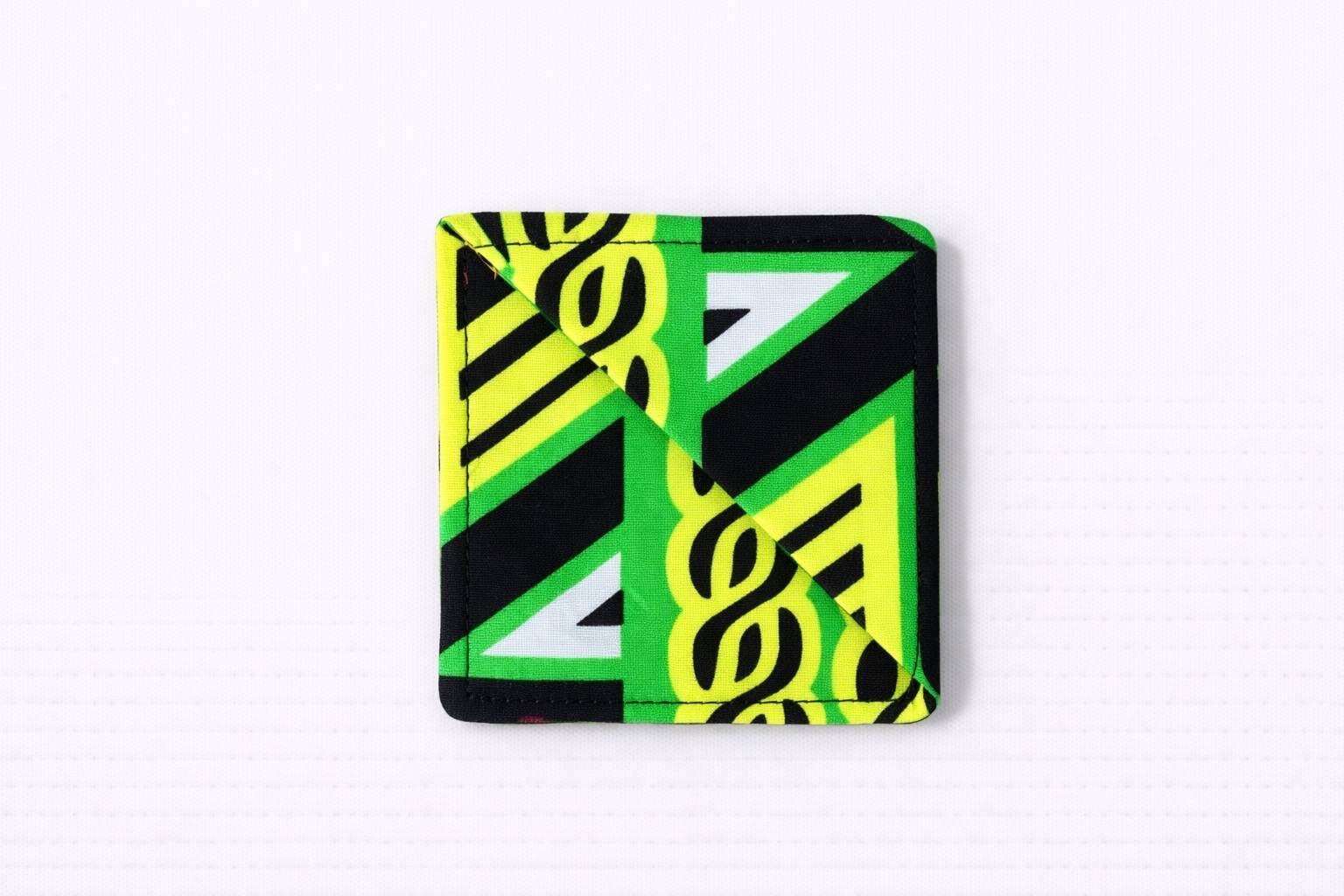 Black, green, yellow, & white corner bookmark on light gray background