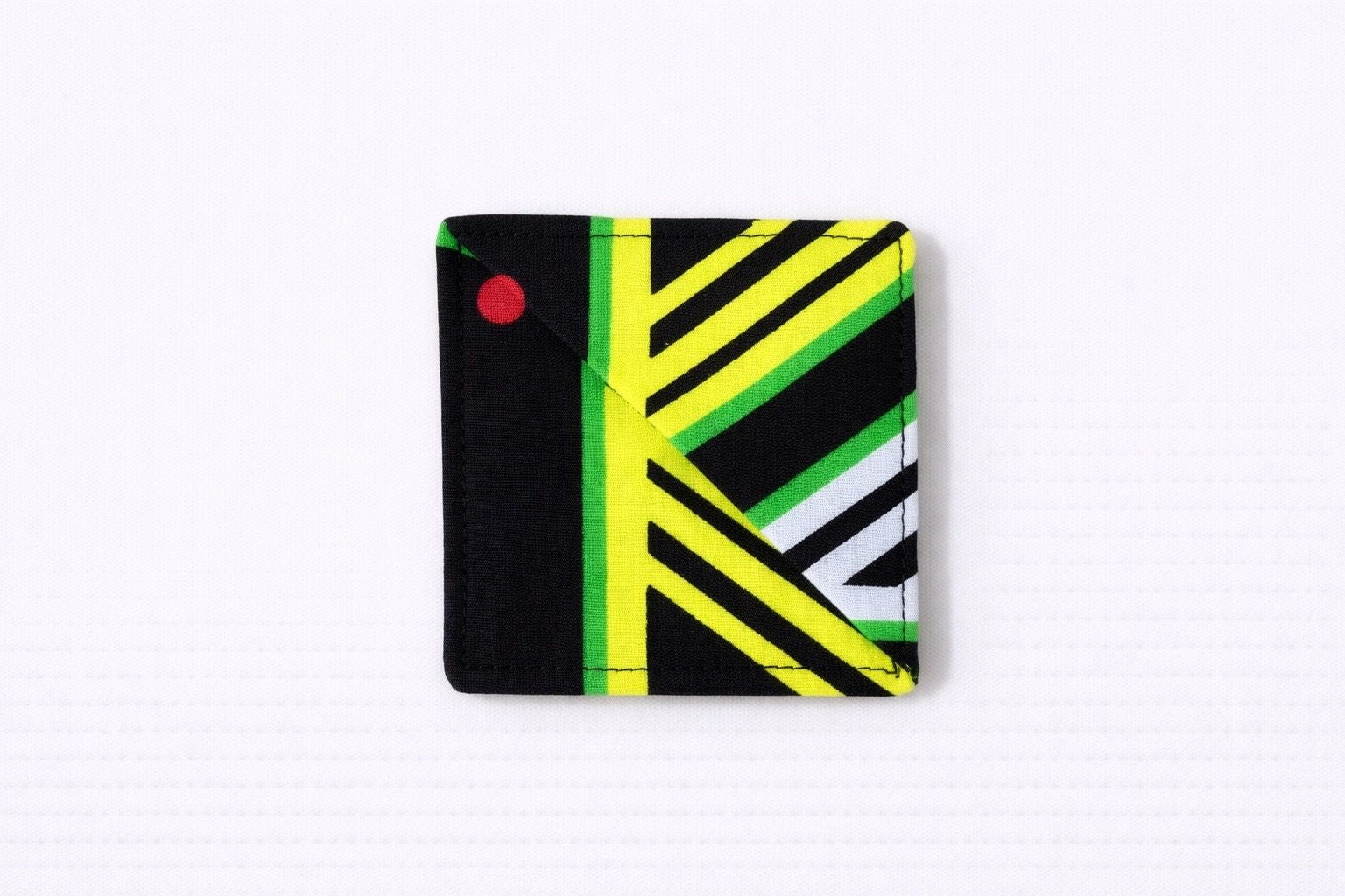 Black, green, yellow, & white corner bookmark on light gray background
