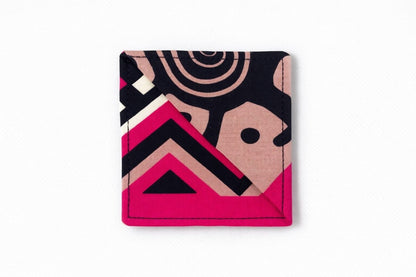 Black, pink, beige, and cream corner bookmark on light gray background