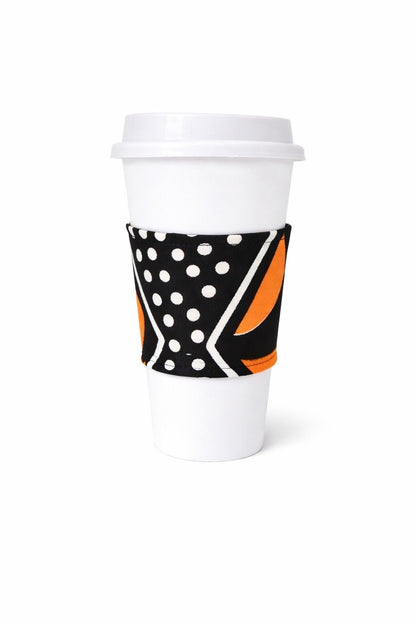 Black, white, & orange African wax print cup sleeve on coffee cup