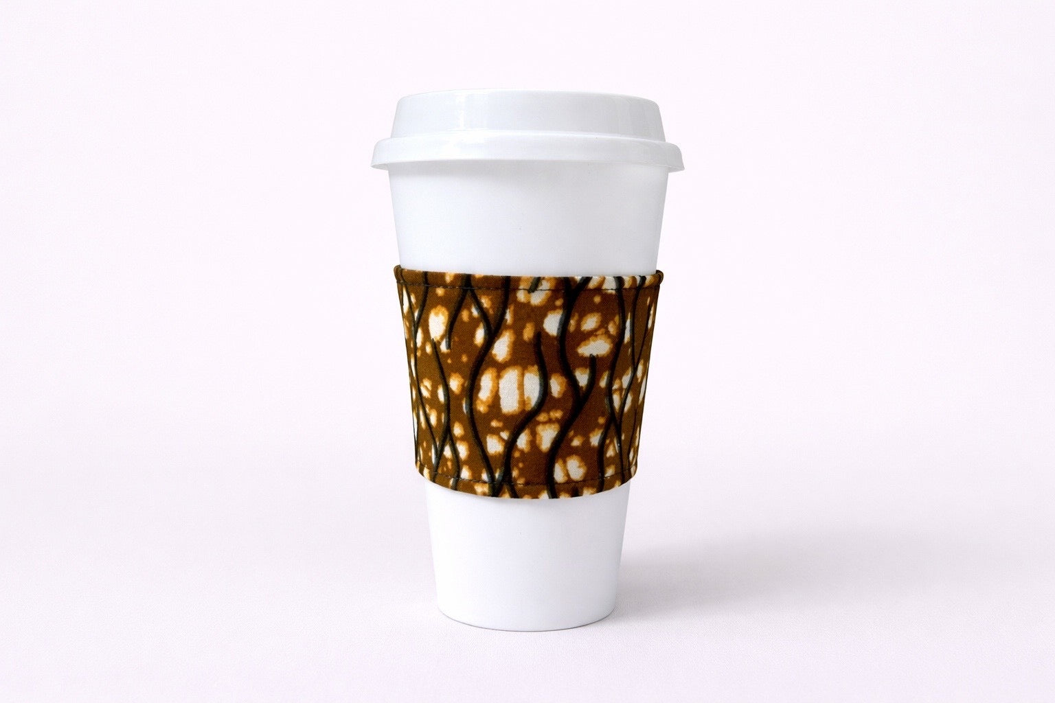 Cream, dark blue, brown, red, white African wax print cup sleeve on coffee cup