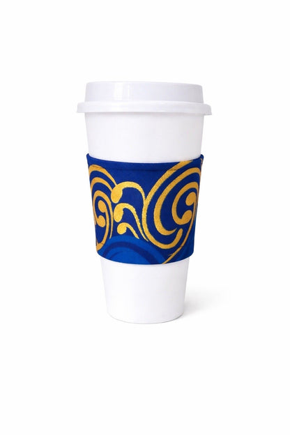 Dark blue, blue, white, & gold African wax print cup sleeve on coffee cup