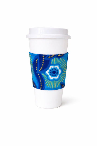 Dark blue, blue, white, & gold African wax print cup sleeve on coffee cup