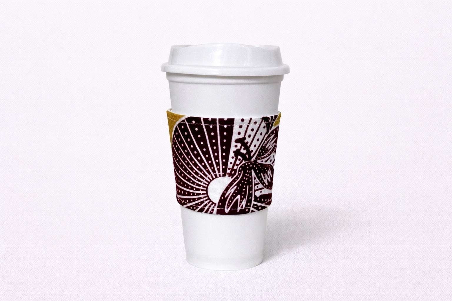 Green, dark brown, & white African wax print cup sleeve on coffee cup