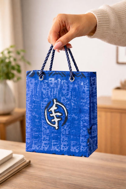 Blue, black, & white handmade African fabric extra small gift bag in lifestyle shot