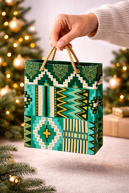 Dark green, green, white, & gold handmade African fabric extra small gift bag in lifestyle shot