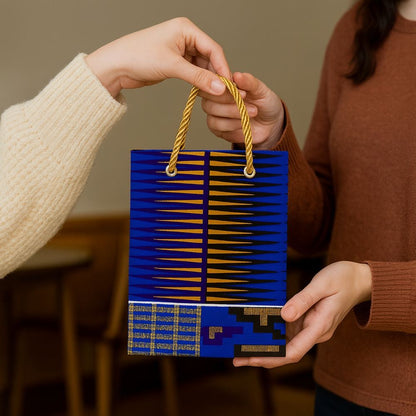 Royal blue, blue, black, white,  & gold handmade African fabric extra small gift bag in lifestyle shot