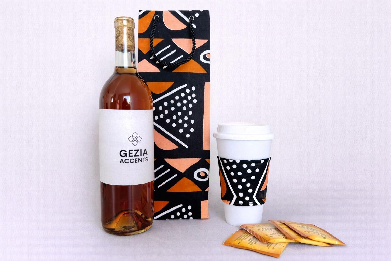 Black, white, & orange wine bag and cup sleeve on a white background