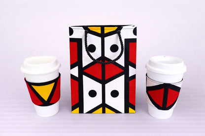 Red, yellow, black, & white cup sleeves and small bag on a white background