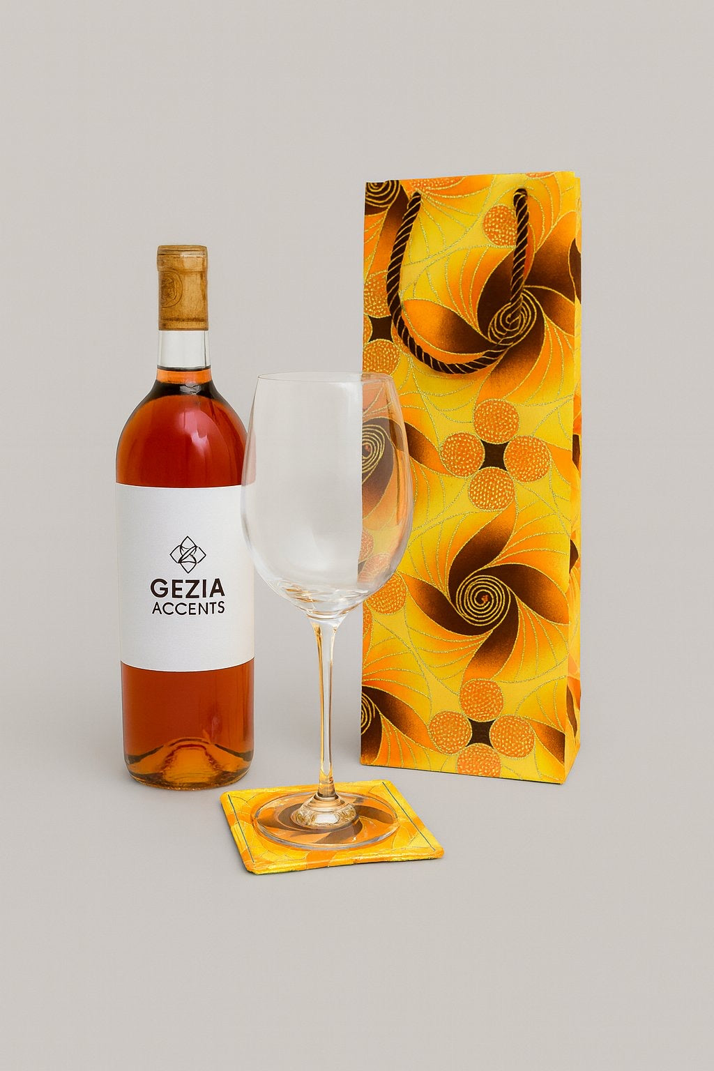 Yellow, brown, orange, & gold wine bag & coaster on a white background
