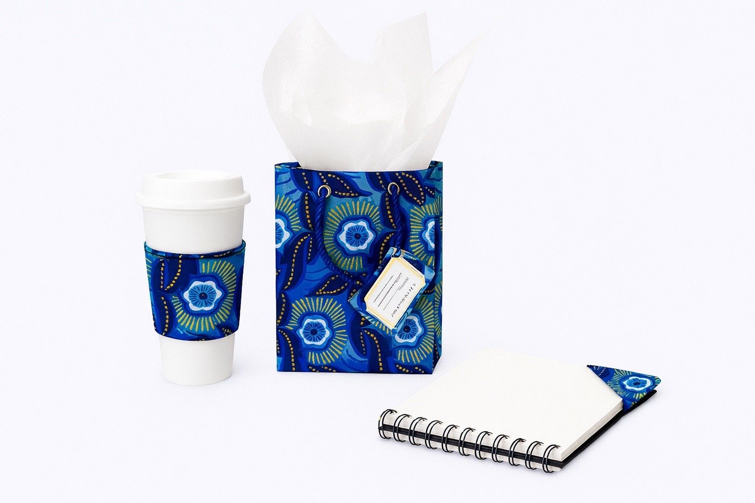dark blue, blue, white, & gold extra small bag, cup sleeve & corner bookmark on a white background