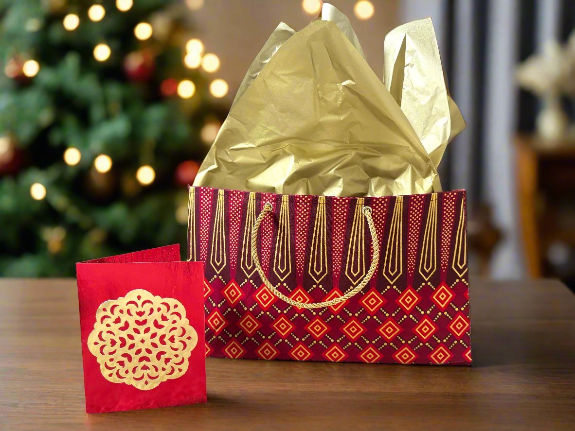 Handmade Maroon, Red, and Gold Medium Horizontal Bag  on a table with a Christmas tree in the background- Gezia Accents