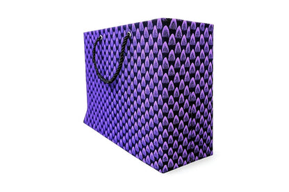 Side view of a purple and black patterned horizontal gift bag with black handle on a white background